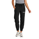 Person wearing black jogger pants with text on a white background